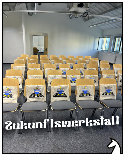 Stühlreihen. Noch ohne Menschen. Geschenketüten auf den Stühlen. Titel:" Zukunftswerkstatt"